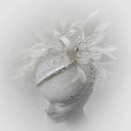 A feminine ivory teardrop fascinator with feathers, crystals, pearls and veil, perfect for brides, bridesmaids or wedding guests.